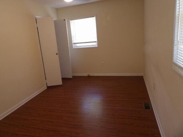 empty room featuring dark hardwood / wood-style floors