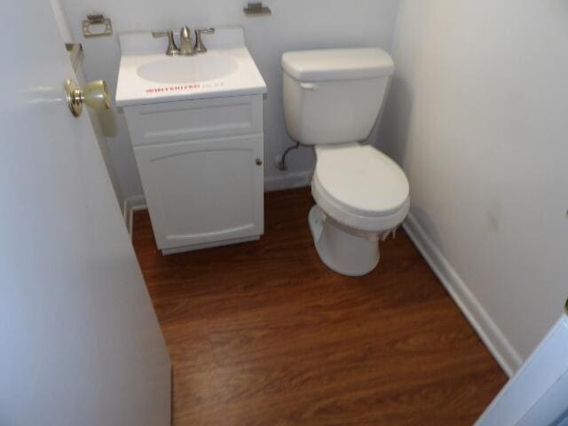 bathroom featuring vanity, hardwood / wood-style flooring, and toilet