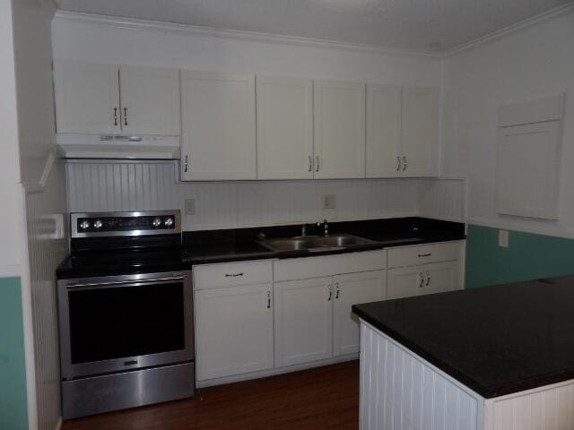 kitchen with stainless steel range with electric cooktop, white cabinetry, ornamental molding, dark hardwood / wood-style floors, and sink