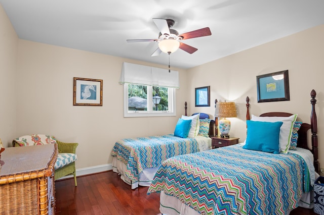 bedroom with ceiling fan and dark hardwood / wood-style floors