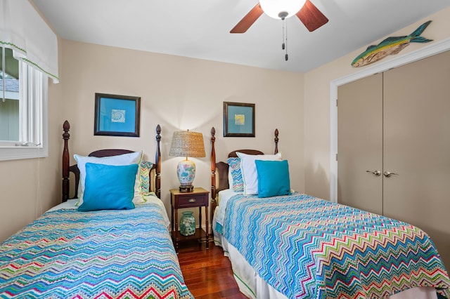 bedroom with ceiling fan, a closet, and dark hardwood / wood-style flooring