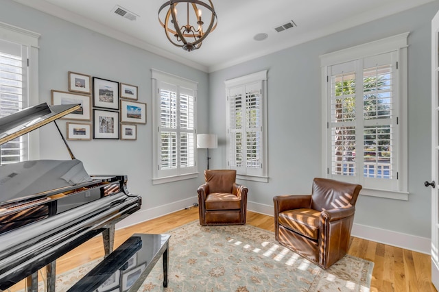 sitting room featuring wood finished floors, visible vents, and baseboards