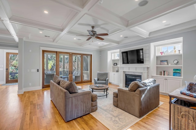 living room featuring french doors, coffered ceiling, light wood finished floors, and a premium fireplace