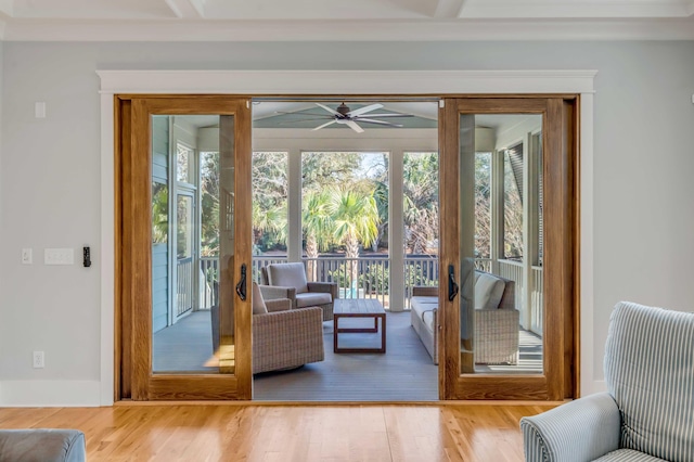 doorway with baseboards and wood finished floors