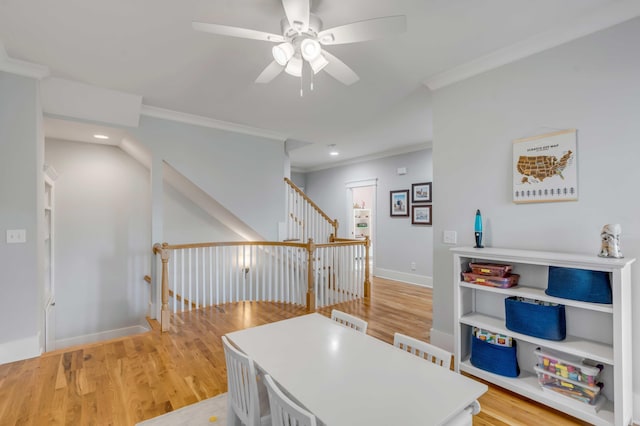 interior space with ornamental molding, light wood-type flooring, and baseboards