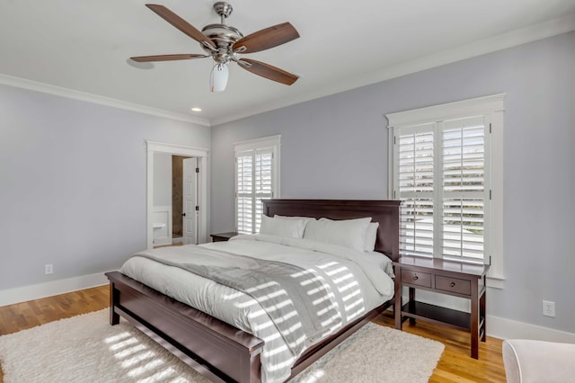 bedroom with a ceiling fan, crown molding, baseboards, and wood finished floors