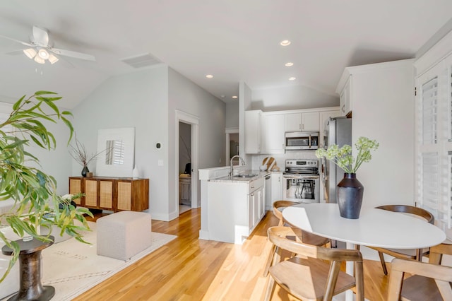 dining space featuring ceiling fan, recessed lighting, visible vents, vaulted ceiling, and light wood finished floors