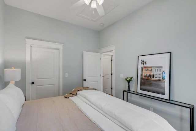 bedroom with attic access and a ceiling fan