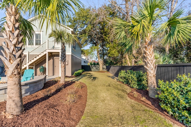 view of yard with stairway and a fenced backyard