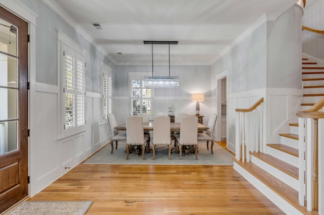 dining space featuring plenty of natural light, stairway, light wood-style flooring, and visible vents