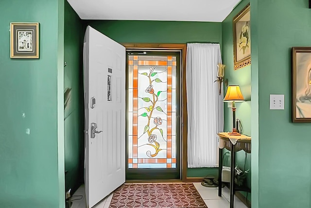 doorway to outside with tile patterned floors