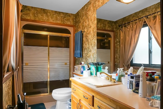 bathroom featuring vanity, toilet, tile patterned flooring, and a shower with door