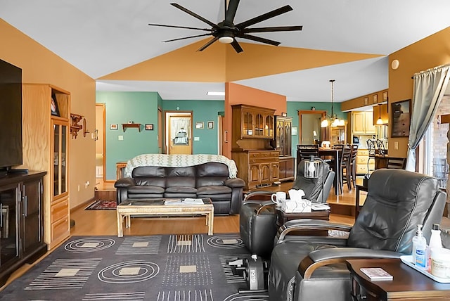 living room featuring hardwood / wood-style flooring, vaulted ceiling, and ceiling fan with notable chandelier