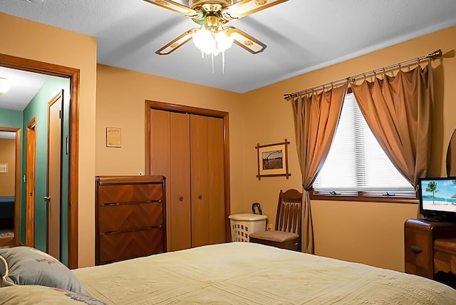 bedroom with ceiling fan and a closet