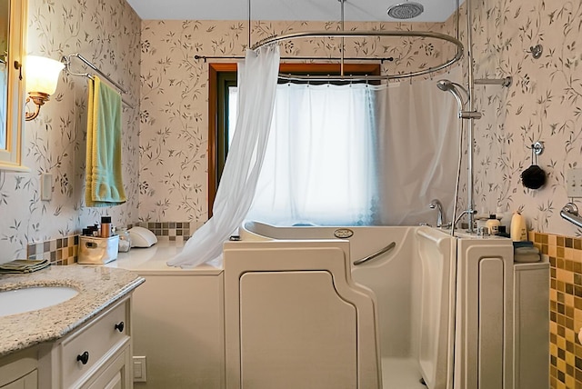 bathroom with vanity, washer / dryer, and a shower with curtain