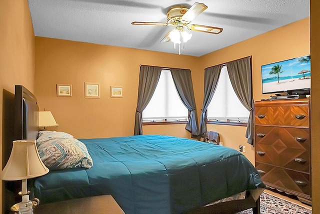 bedroom featuring a textured ceiling and ceiling fan