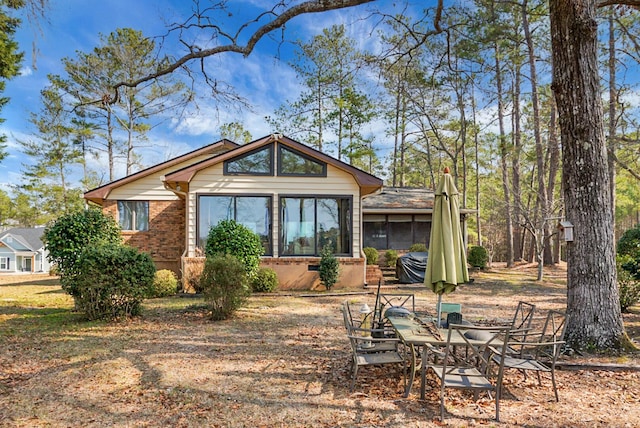 rear view of property with a sunroom