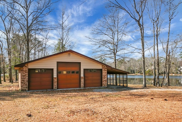 garage featuring a carport and a water view