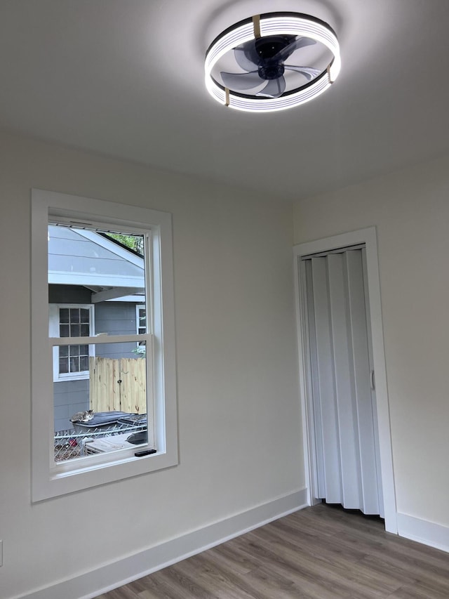 interior space featuring wood finished floors and baseboards
