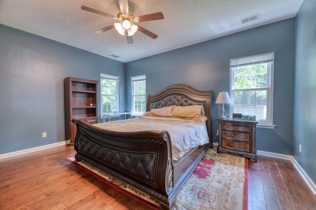 106 Trimley Ct, Goose Creek, SC 29445 - bedroom featuring hardwood / wood-style flooring, a textured ceiling, baseboards, and a ceiling fan