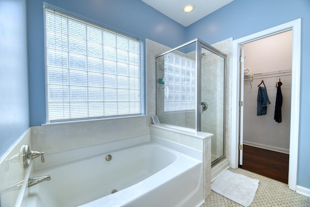 106 Trimley Ct, Goose Creek, SC 29445 - full bath featuring a shower stall, a walk in closet, a garden tub, baseboards, and tile patterned flooring