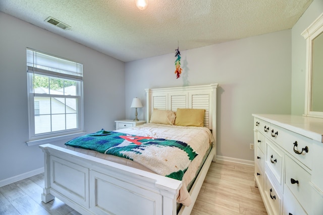 106 Trimley Ct, Goose Creek, SC 29445 - bedroom with light wood finished floors, a textured ceiling, and baseboards