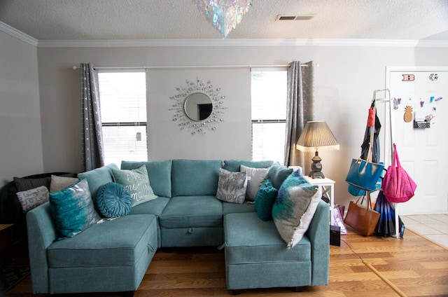 living room featuring ornamental molding, a wealth of natural light, and hardwood / wood-style flooring