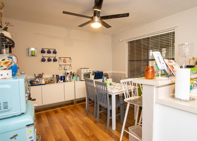 dining room with ceiling fan and wood-type flooring