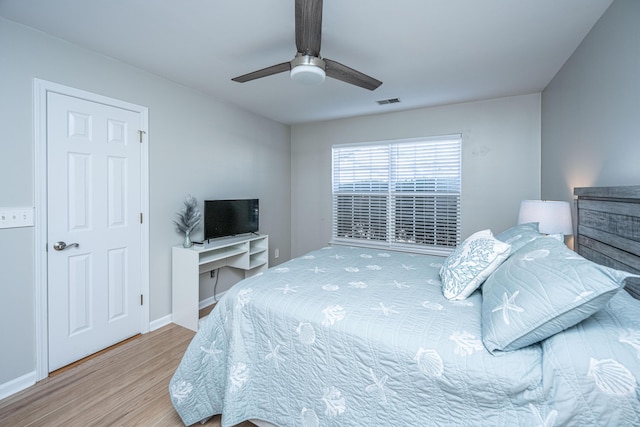 bedroom with hardwood / wood-style flooring and ceiling fan