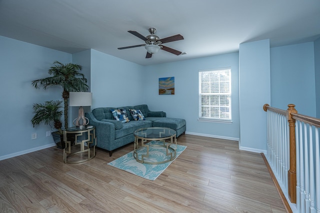 living room with light hardwood / wood-style floors and ceiling fan