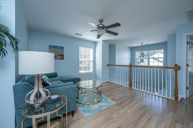 living area featuring ceiling fan and light wood-type flooring