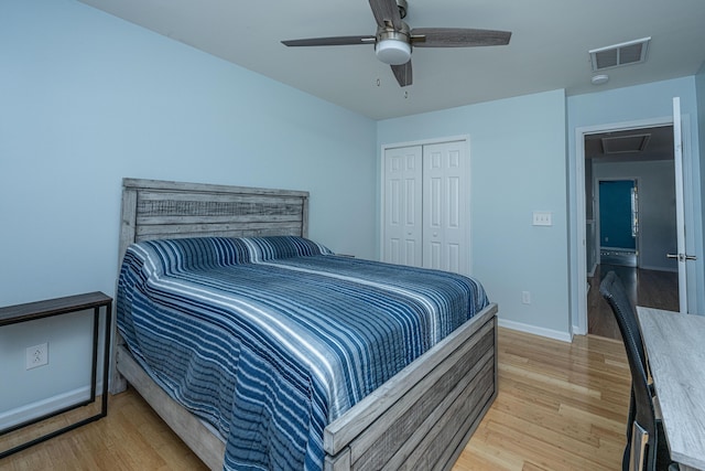 bedroom featuring ceiling fan, light hardwood / wood-style floors, and a closet