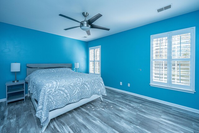 unfurnished bedroom featuring ceiling fan and dark hardwood / wood-style flooring