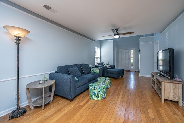 living room featuring ceiling fan and wood-type flooring