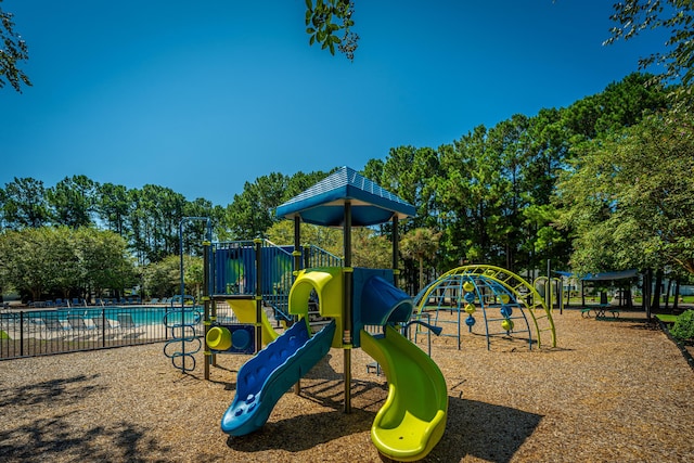 view of jungle gym with a community pool