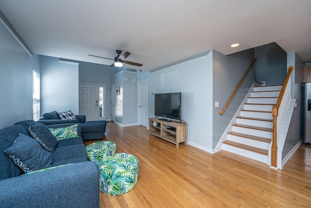 living room featuring hardwood / wood-style floors and ceiling fan