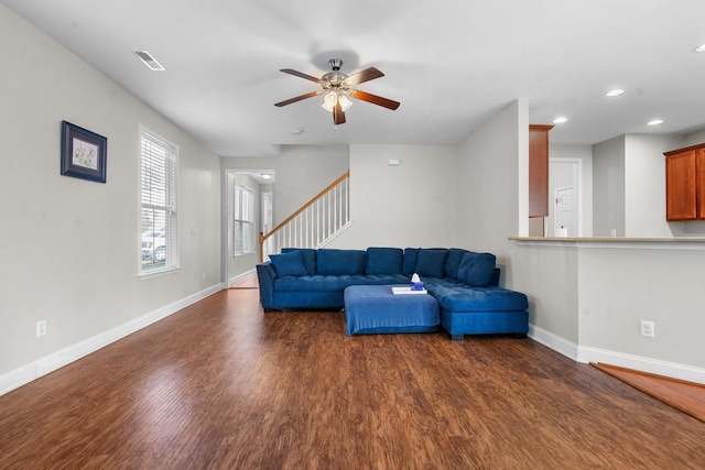 living room featuring dark hardwood / wood-style floors and ceiling fan