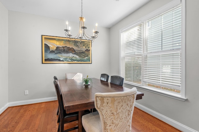 dining room with a notable chandelier and light hardwood / wood-style flooring