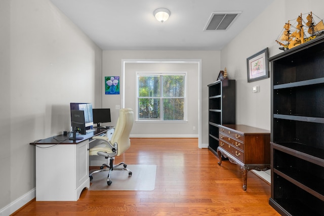 office space with light wood-type flooring