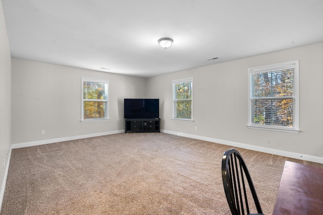 unfurnished living room featuring carpet