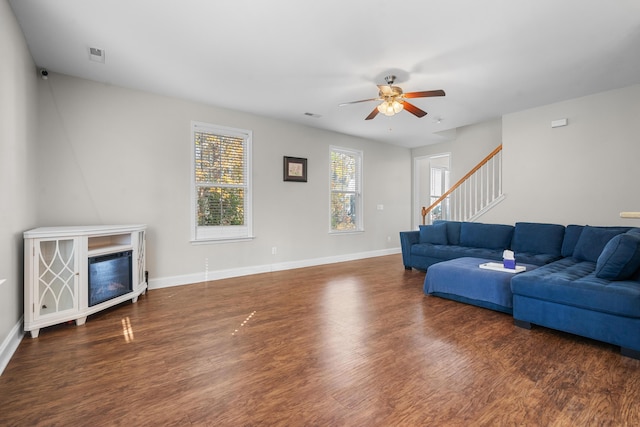 living room with ceiling fan, dark hardwood / wood-style flooring, and a fireplace