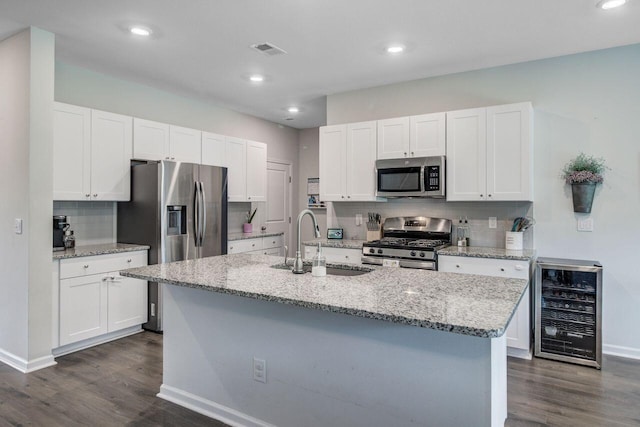 493 Spanish Wells Rd, Summerville, SC 29486 - kitchen with appliances with stainless steel finishes, wine cooler, dark wood finished floors, white cabinets, and recessed lighting