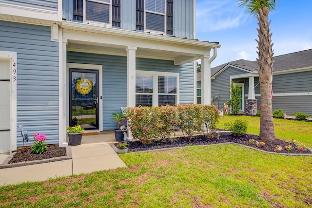 493 Spanish Wells Rd, Summerville, SC 29486 - property entrance featuring a lawn, a porch, and board and batten siding
