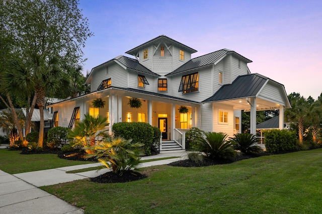 4009 E Amy Ln, Johns Island, SC 29455 - modern inspired farmhouse featuring a standing seam roof, metal roof, a yard, and covered porch