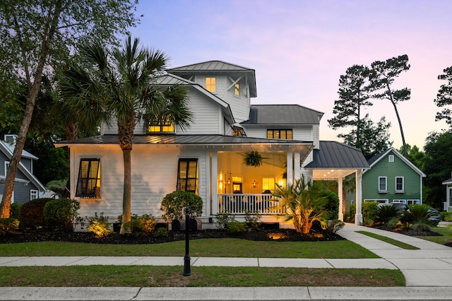 4009 E Amy Ln, Johns Island, SC 29455 - view of front facade featuring a standing seam roof, a porch, metal roof, and a yard