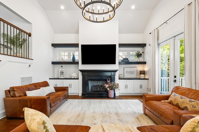 4009 E Amy Ln, Johns Island, SC 29455 - living room with vaulted ceiling, wood finished floors, a chandelier, and a fireplace with flush hearth