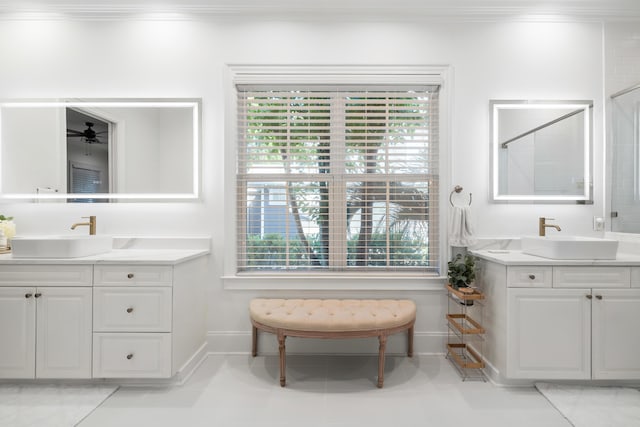4009 E Amy Ln, Johns Island, SC 29455 - bathroom with crown molding, baseboards, healthy amount of natural light, a shower, and two vanities