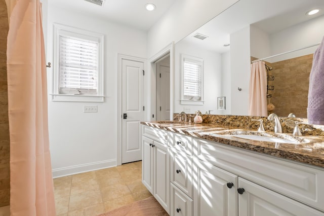 4009 E Amy Ln, Johns Island, SC 29455 - full bath featuring tile patterned flooring, a tile shower, double vanity, and recessed lighting