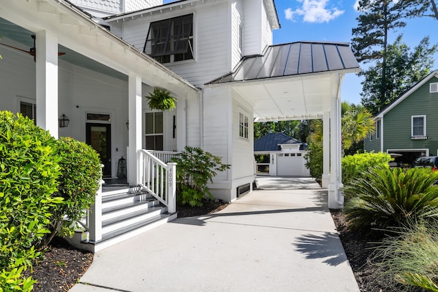 4009 E Amy Ln, Johns Island, SC 29455 - property entrance with a standing seam roof, concrete driveway, metal roof, and a garage