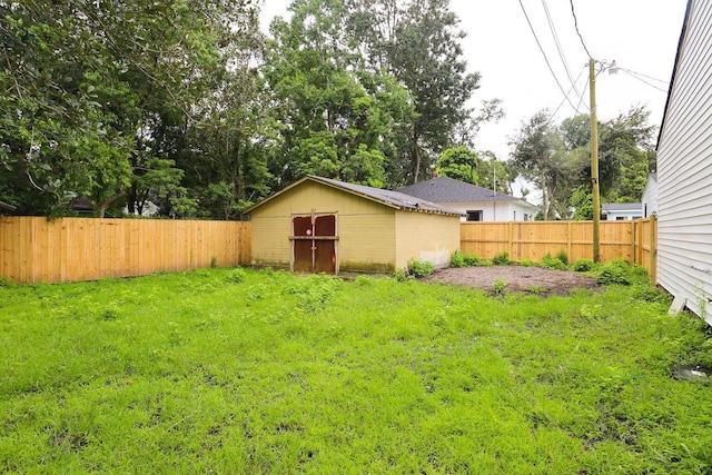 view of yard featuring a fenced backyard and an outdoor structure